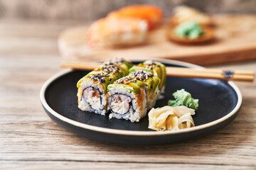  Plate of shrimp and cheese cream uramaki sushi on a wooden surface