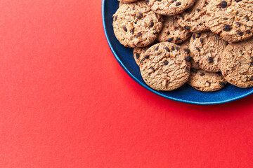  Plate of chocolate cookies on a red background