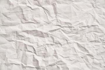 White crumpled paper texture with wrinkles. Damaged and torn sheet
