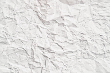 White crumpled paper texture with wrinkles. Damaged and torn sheet