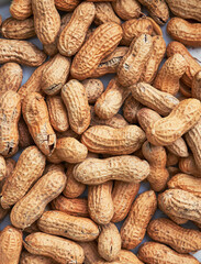 Healthy roasted unpeeled peanuts. Brown nuts texture