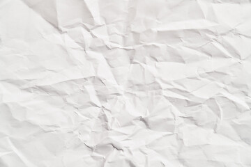 White crumpled paper texture with wrinkles. Damaged and torn sheet