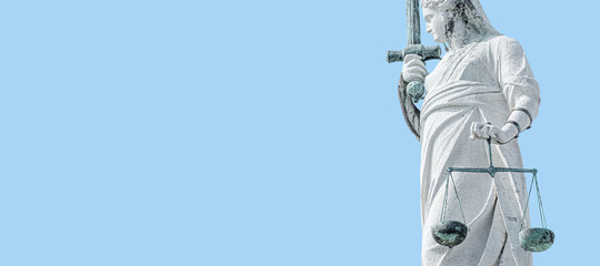 Banner with ancient statue of goddess Justice with sword, scale as decoration at top of Doge Palace in Venice, Italy, at blue sky background with copy space. Concept of cultural historical heritage.