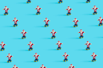 Pattern made of Santa Claus riding skateboards on pastel blue background