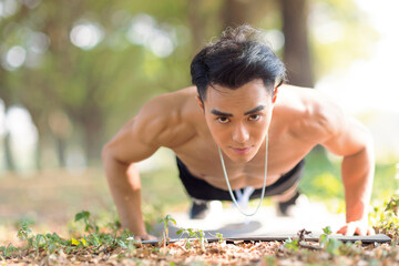 Fittness asian  man doing exercises in the park