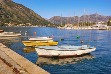 Fototapeta na wymiar Sunny autumn Mediterranean landscape. Montenegro, Adriatic Sea. View of Kotor Bay near Old Town of Kotor. Fishing boats and yachts