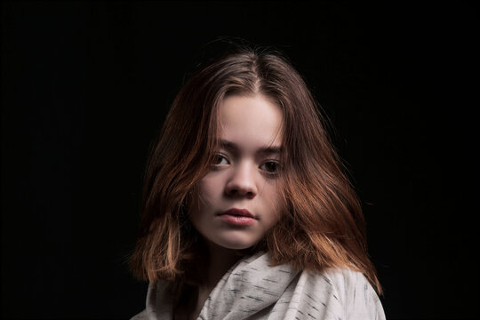 A young girl on a dark background