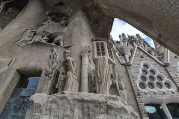 Barcelona, Spain - 22 Nov, 2021: Statues on the exterior of the Sagrada Familia designed by modernista architect Antoni Gaudi. Barcelona