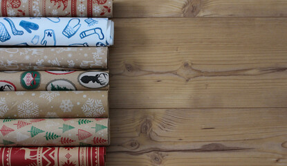 christmas wrapping paper rolls on wooden ground