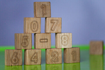 Arithmetic, mathematic, learning concept, numbers background with wooden cubes. Shallow Depth of...