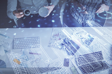 Fototapeta na wymiar Double exposure of man and woman working together and the buildings hologram drawing. Computer background. Top View. Smart city concept.