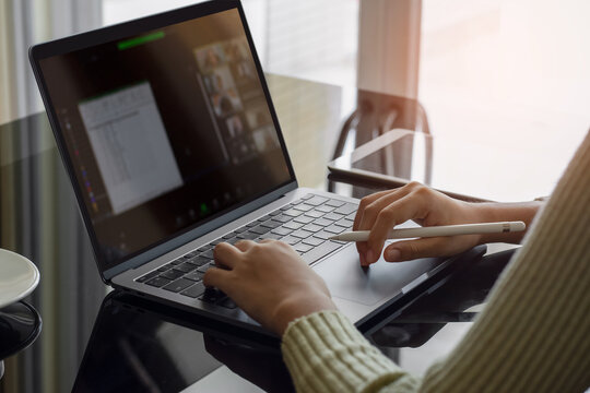 Young asian woman working at home having online group video conference on laptop computer. Female student online learning at home. 