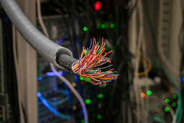 There is a damaged stranded trunk cable in the server room. Breakage in the communication wire - obrazy, fototapety, plakaty