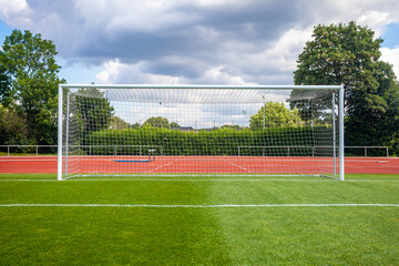 soccer goal on a green lawn on the field