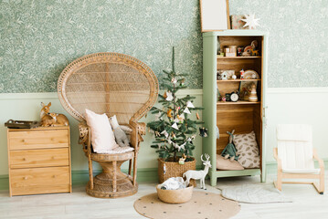 New Year's decor of the children's room: a wicker armchair with pillows, a Christmas tree with...