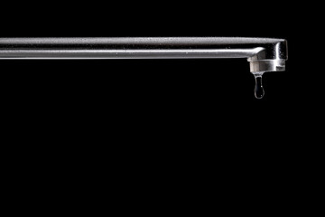 The last drop of clean tap water, isolated on a black background.