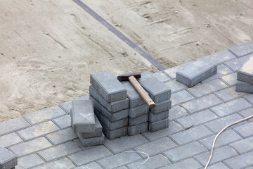 Laying paving slabs in the yard.