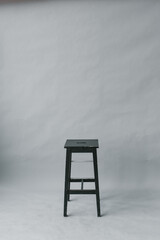 black stool stool on a gray paper background in a photo studio