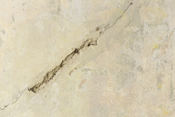 Fototapeta premium The white wall building cracked by weather or moisture. Cracked on white and yellow wall texture.