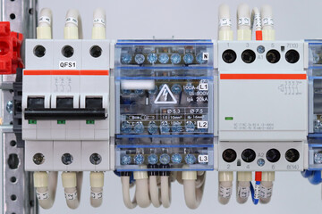 3-pole automatic current switch, bus wire connector, electromagnetic contactor on a din rail.