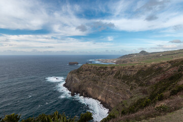 Fototapeta na wymiar Seascape. cliffs in the west of Sao Miguel with Mosteiros town in the background. Azores. Portugal