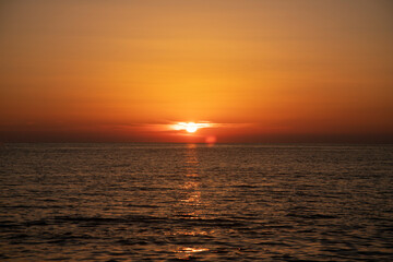 Fototapeta na wymiar Sunset at sea, sun at sunset