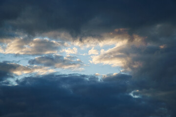 Naklejka na ściany i meble Clouds illuminated by the sun in the sky as background