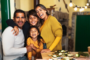 Happy Hispanic family enjoying holidays together at home - 473136569