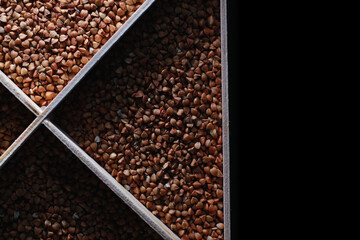 A set of grain cereals. Rice, buckwheat and millet groats in a wooden tray. A grocery set of cereals. Import of grain.