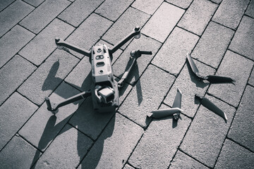 Crashed drone lays on the ground and damaged