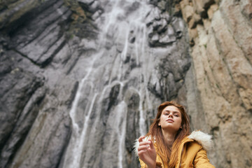 woman in yellow jacket hiking in the mountains travel adventure