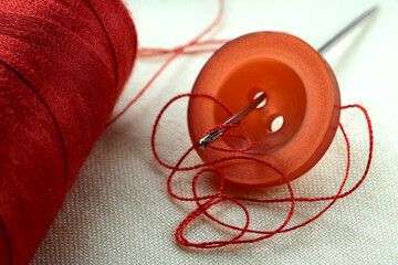 Red button with a needle
