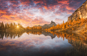 Incredible purple sunrise on Federa Lake in the Dolomite Apls. Autumn mountains landscape with Lago...