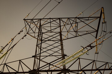 High voltage tower with power lines. View from bottom to on the top of tower's voltage