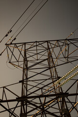 High voltage tower with power lines. View from bottom to on the top of tower's voltage