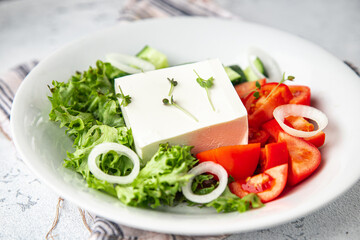 feta salad cucumber, tomato, lettuce, vegetables healthy meal diet snack on the table copy space food background rustic. top view keto or paleo diet veggie vegan or vegetarian food