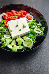feta salad cucumber, tomato, lettuce, vegetables healthy meal diet snack on the table copy space food background rustic. top view keto or paleo diet veggie vegan or vegetarian food