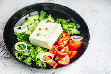 feta salad cucumber, tomato, lettuce, vegetables healthy meal diet snack on the table copy space food background rustic. top view keto or paleo diet veggie vegan or vegetarian food