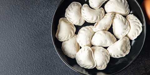 vareniki raw frozen stuffed dumplings semifinished meal snack on the table copy space food background