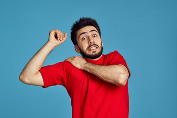 man in red t-shirt health problems emotions symptoms blue background