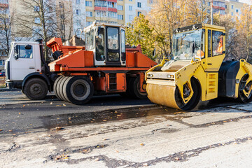 Heavy duty vibratory road roller for asphalt concrete works and road repairs. Heavy machinery when repairing asphalt pavement.