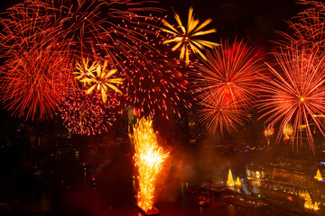 Fireworks lit up in the New Year's festival are scattered across the sky at midnight in a variety of colors in the middle of the Chao Phraya River, Thailand.