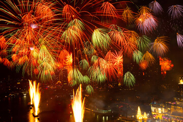 Fireworks lit up in the New Year's festival are scattered across the sky at midnight in a variety...