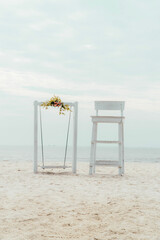 potrait shot of lookout tower and swing on beach