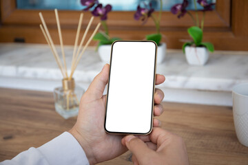 male hands holding phone with isolated screen over table cafe