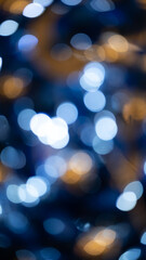Blue bokeh abstract winter background. Blur defocused glitter lights. Circular points. Colorful.