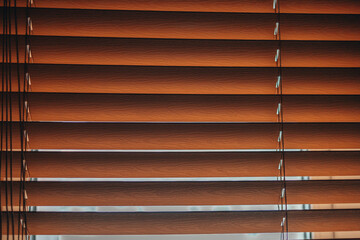 Horizontal wooden blinds on the window.