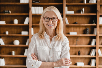Smart caucasian middle-aged mature businesswoman librarian psychologist boss teacher in glasses...