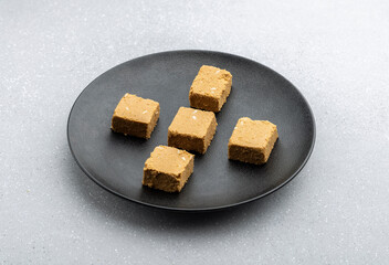 

Til mawa cake or Gajak  is a dry sweet cake - made of sesame seeds, ground nuts and jaggery, consumed in India  especially in winter during Makar Sankranti and Lohri festival