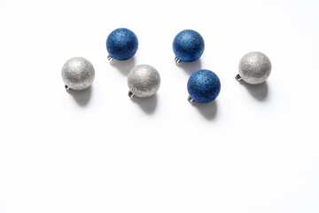 Top view of six christmas balls of silver and blue color isolated on white background with copy space